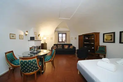 a room with a bed and a table and chairs at Pantheon's Arch by BuddyRent in Rome