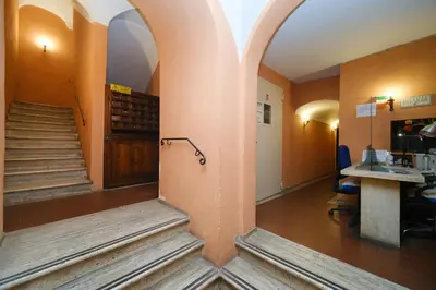 a hallway with stairs and an archway in a building at Pantheon's Arch by BuddyRent in Rome