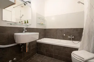 a bathroom with a sink and a toilet and a tub at Casa Lucrezio Saint Peter's in Rome