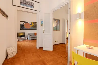 a living room with a white door and a table at Casa Lucrezio Saint Peter's in Rome