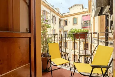 a balcony with two chairs and a table at Casa Lucrezio Saint Peter's in Rome