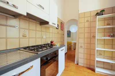 a kitchen with a stove top oven in a room at Casa Lucrezio Saint Peter's in Rome