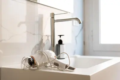 a bathroom sink with a blow dryer on it at Barigelli Apartment in Rome