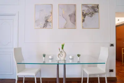 a dining room with a glass table and two chairs at Luxury Stay Piazza di Spagna in Rome