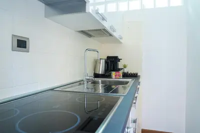 a kitchen with a sink and a counter top at Luxury Stay Piazza di Spagna in Rome