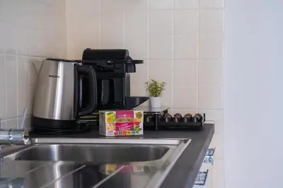 a kitchen counter with a sink and a coffee maker at Luxury Stay Piazza di Spagna in Rome