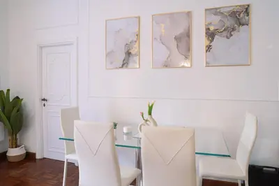 a dining room with a glass table and white chairs at Luxury Stay Piazza di Spagna in Rome