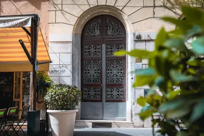 a large wooden door on the side of a building at Luxury Stay Piazza di Spagna in Rome