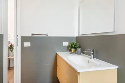 a bathroom with a sink and a white cabinet at White Flat 60 -San Lorenzo- in Rome