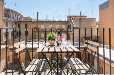 a table on a balcony with a view of a city at White Flat 60 -San Lorenzo- in Rome