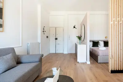 a living room with a couch and a bed at White Flat 60 -San Lorenzo- in Rome