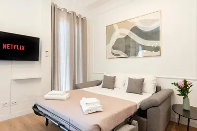 a bedroom with a bed and a tv in a room at White Flat 60 -San Lorenzo- in Rome