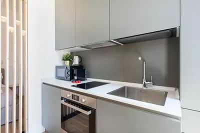 a kitchen with a sink and a microwave at White Flat 60 -San Lorenzo- in Rome