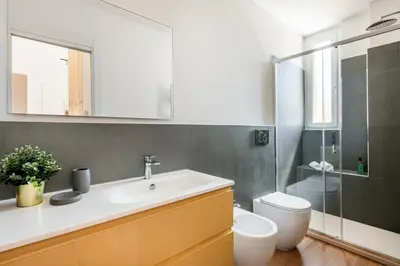 a bathroom with a sink and a toilet and a mirror at White Flat 60 -San Lorenzo- in Rome
