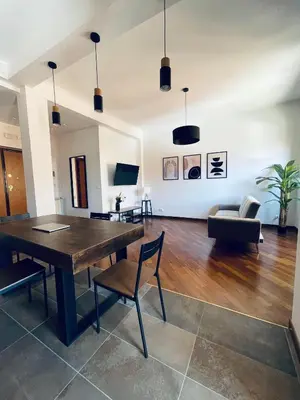 a living room with a wooden table and chairs at Casa Giulia Monteverde in Rome