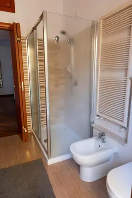 a bathroom with a shower and a toilet and a sink at Casa Giulia Monteverde in Rome