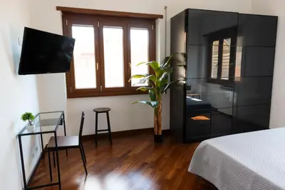 a bedroom with a large black cabinet with a tv at Casa Giulia Monteverde in Rome