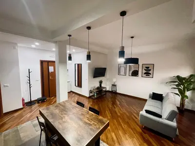 a living room with a table and a couch at Casa Giulia Monteverde in Rome