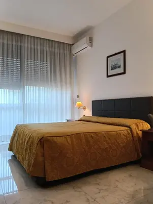 a bedroom with a large bed and a desk at Monolocale Roma metro A Cornelia in Rome