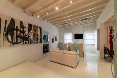 a living room with a couch and paintings on the wall at Cappellari 4 - FromHometoRome in Rome