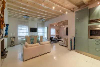 a living room with a kitchen and a dining room at Cappellari 4 - FromHometoRome in Rome