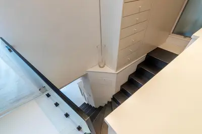 a staircase leading up to a room with white cabinets at Cappellari 4 - FromHometoRome in Rome