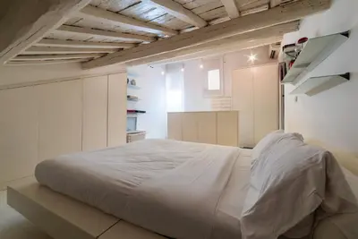 a bedroom with a large white bed in a room at Cappellari 4 - FromHometoRome in Rome