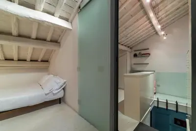 a small room with a bed and a glass wall at Cappellari 4 - FromHometoRome in Rome