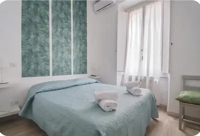 a bedroom with a bed with towels on it at Green House in Rome
