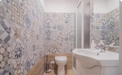 a bathroom with a white toilet and a sink at Green House in Rome