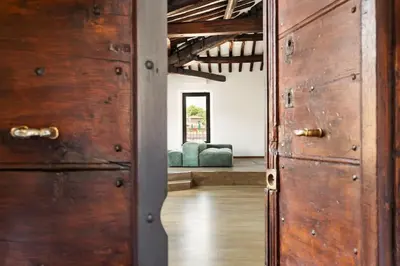 an open door to a room with two blue couches at Casa Garibaldi, a Burghesius home in Rome