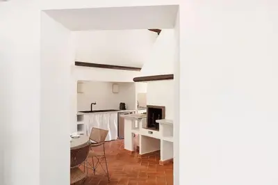 a kitchen and living room with a table and chairs at Casa Garibaldi, a Burghesius home in Rome