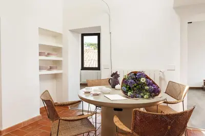 a dining room with a table and chairs at Casa Garibaldi, a Burghesius home in Rome
