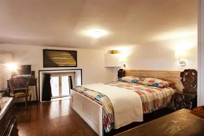 a bedroom with a bed and a chair in it at Ninohouse in Rome