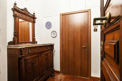 a room with a wooden cabinet and a door at Ninohouse in Rome
