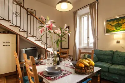 a dining room with a table with a bowl of fruit at Ninohouse in Rome