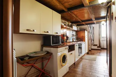 a kitchen with a washer and dryer in it at Ninohouse in Rome