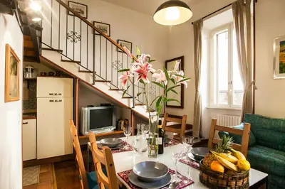 a kitchen and dining room with a dining table with a tableablish at Ninohouse in Rome
