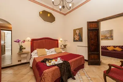 a bedroom with a bed with a tray of food on it at La Residenza del Sole al Pantheon in Rome