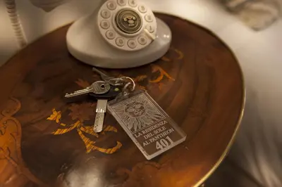 a table with a phone and a key on it at La Residenza del Sole al Pantheon in Rome