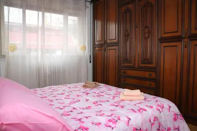 a bedroom with a pink bed with towels on it at A Casa di Lilly in Rome