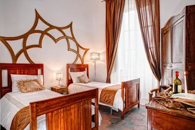 a bedroom with two beds and a window at Romance al Colosseo in Rome
