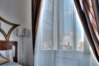 a bedroom with a window with a view of a city at Romance al Colosseo in Rome