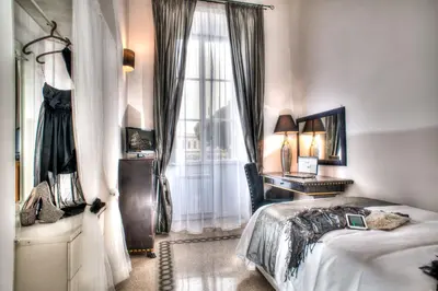 a bedroom with a bed and a window at Romance al Colosseo in Rome