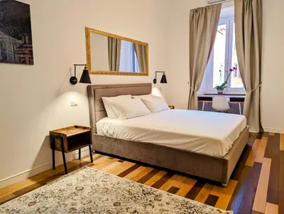a bedroom with a bed and a mirror on the wall at Luxury Gallery Suites in Rome