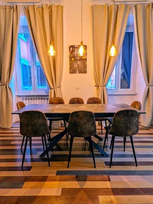 a dining room with a table and chairs at Luxury Gallery Suites in Rome