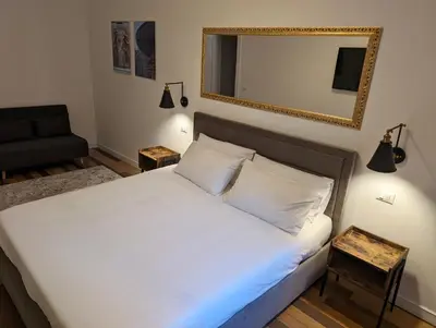 a bedroom with a bed with a mirror and a chair at Luxury Gallery Suites in Rome