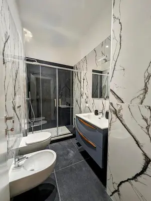 a bathroom with two sinks and a toilet and a mirror at Luxury Gallery Suites in Rome