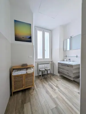 a white bathroom with a sink and a tub and a sinkessment at Luxury Gallery Suites in Rome