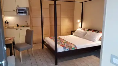 a bedroom with a bed and a chair and a table at HomeFlat in Rome